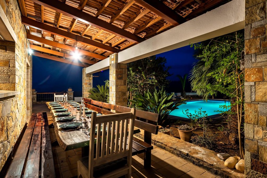 Dining table set on the balcony with a view of the pool